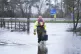 An Canal and River Trust worker walks through flood water at