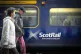 Commuters walking past a ScotRail train at Edinburgh's Waver