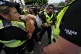 Police remove a pro-Palestine campaigner during a protest ou