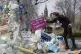 Activist Dianne Peterson places a sign on an art installatio