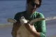 A volunteer carries a Green Sea Turtle after it was caught t