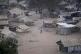 People stand by their houses in Juba, South Sudan, on Februa