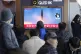 A TV screen shows a file image of North Korea's missile laun