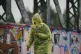 A person shields themself from the weather in Primrose Hill,