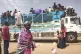 People board a truck as they leave Khartoum, Sudan, on June 