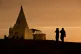The sun sets as women visit a Yazidi shrine overlooking at K