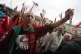 A government supporter wears a portrait of Belarus President