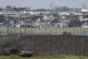 Israeli soldiers drive a tank on the border with Gaza Strip,