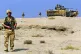 A British soldier patrols in Iraq, 2004