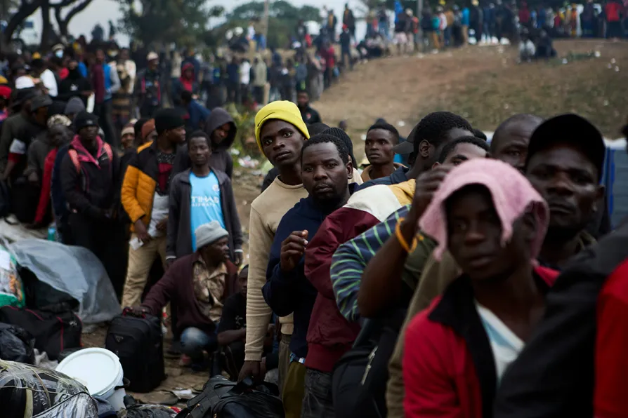 Migrants and police clash in South Africa as thousands processed for deportation